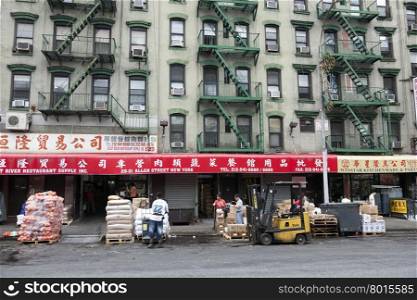 hard working people in front of shops on allen street in chinatown manhattan new york city