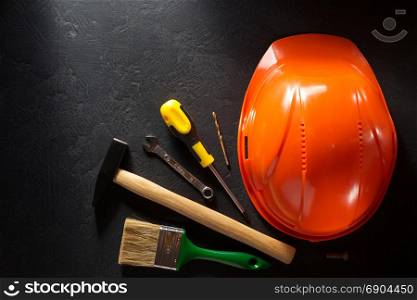 hardhat and tools on black background