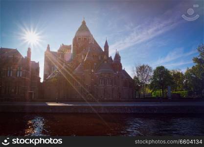 Harlem Cathedral of Saint Bavo (St. Bavo Kathedraal) with sun flare, view over canal. Haarlem, Netherlands. Cathedral of Saint Bavo, Harlem, Netherlands