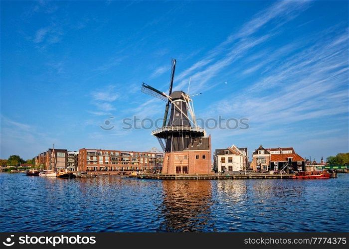 Harlem cityscape - landmark windmill De Adriaan on Spaarne river with boats. Harlem, Netherlands. Panorama of Harlem, Netherlands