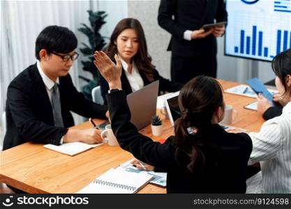 Harmony group businesspeople in meeting room during presentation with dashboard BI financial data displayed on screen, motivated employee raising hand asking question as productive teamwork concept.. Harmony group businesspeople raising hand in meeting room during presentation.