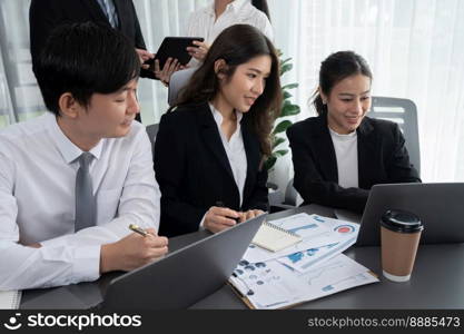 Harmony in office concept as business people analyzing dashboard paper together in workplace. Young colleagues give ideas at manager desk for discussion or strategy planning about project.. Office worker and manager analyze financial report paper in harmony workplace.