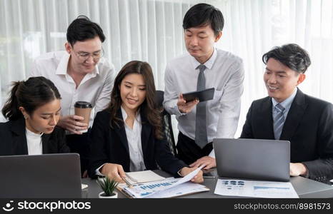 Harmony in office concept as business people analyzing dashboard paper together in workplace. Young colleagues give ideas at manager desk for discussion or strategy planning about project.. Office worker and manager analyze financial report paper in harmony workplace.