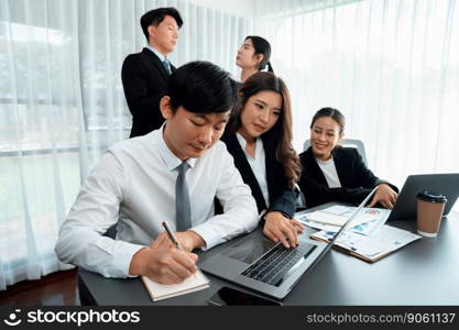 Harmony in office concept as business people analyzing dashboard paper together in workplace. Young colleagues give ideas at manager desk for discussion or strategy planning about project.. Office worker and manager analyze financial report paper in harmony workplace.