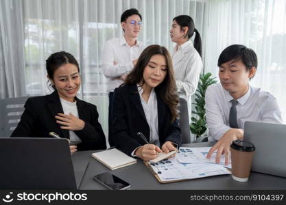 Harmony in office concept as business people analyzing dashboard paper together in workplace. Young colleagues give ideas at manager desk for discussion or strategy planning about project.. Office worker and manager analyze financial report paper in harmony workplace.