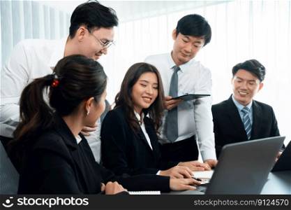 Harmony in office concept as business people analyzing dashboard paper together in workplace. Young colleagues give ideas at manager desk for discussion or strategy planning about project.. Engaging businesspeople working at desk together as concept of harmony in office