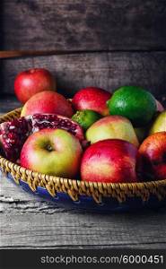harvest of apples,lime,pomegranate and clove on a stylish plate