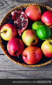 harvest of apples,lime,pomegranate and clove on a stylish plate