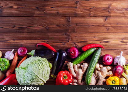 Harvest of many various colorful vegetables on wooden background. Harvest vegetables background