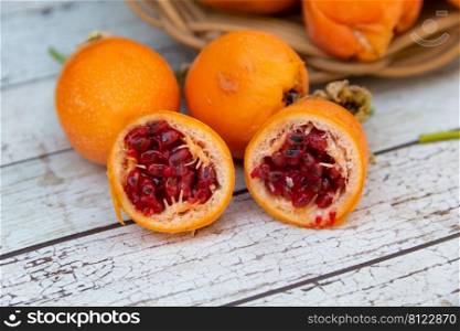 harvest of orange fruits of wild passion fruit on wood. collection of wild passion fruit