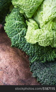 Harvest of rural cabbage. Fresh green cabbage on rustic wooden background