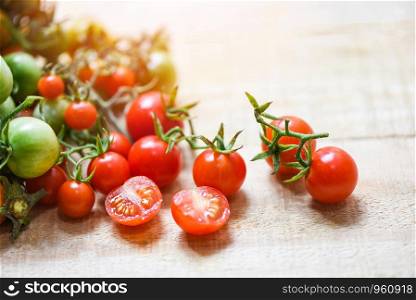 Harvesting fresh tomato organic with green and ripe red tomatoes on wooden background