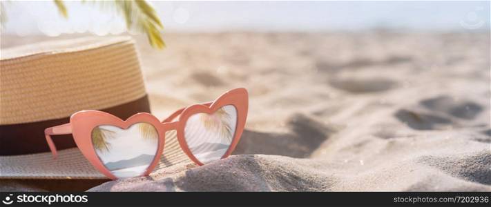 Hat and sunglasses on the tropical sand beach with copy space, Summer vacation concept