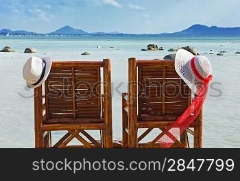 hat on a bamboo chair on the beach