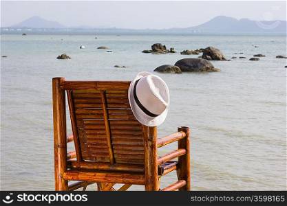 hat on a bamboo chair on the beach