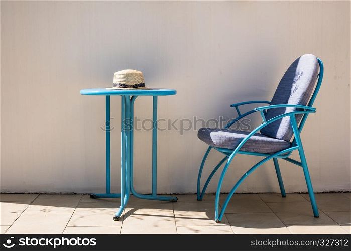 Hat on the outdoor cafe table. Travel summer vacation concept