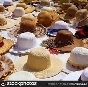 Hats display on a street market outdoor under sunny summer light