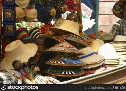 Hats on a market stall, Floating Market, Thailand