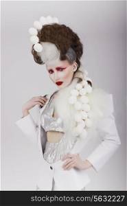 Haute Couture. Extravagant Woman in Cyber Costume and Theatrical Hair-do
