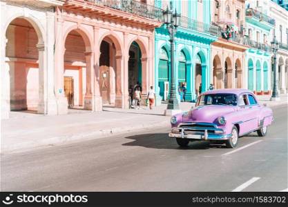 HAVANA, CUBA - APRIL 14, 2017: Classic vintage car in Old Havana, Cuba. The most popular transportation for tourists are used as taxis.. View of yellow classic vintage car in Old Havana, Cuba