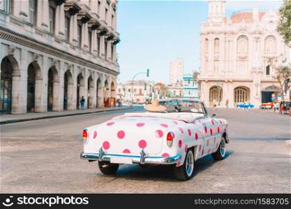 HAVANA, CUBA - APRIL 14, 2017: Classic vintage car the most popular transport for tourist as taxi in old Havana at Cuba.. View of yellow classic vintage car in Old Havana, Cuba