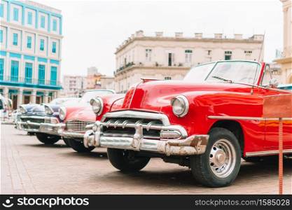 HAVANA, CUBA - APRIL 14, 2017: Classic vintage cars the most popular transport for tourist as taxi in old Havana at Cuba.. View of yellow classic vintage car in Old Havana, Cuba