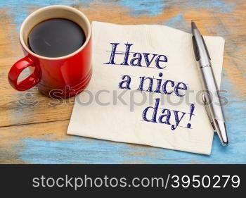 Have a nice day! Handwriting on a napkin with cup of coffee and pen