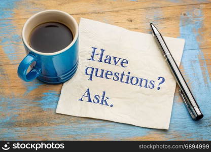 Have questions? Ask. Handwriting on a napkin with a cup of espresso coffee