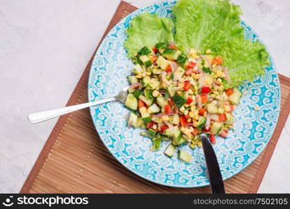 Hawaii style vegetarian raw eating salad/ served in beauiful blue plate on white table. flat lay