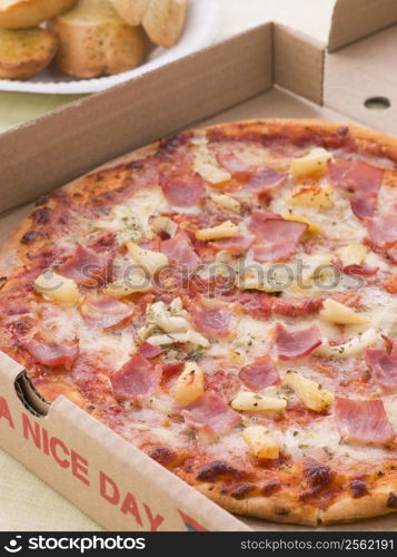 Hawaiian Pizza In A Take Away Box With Garlic Bread