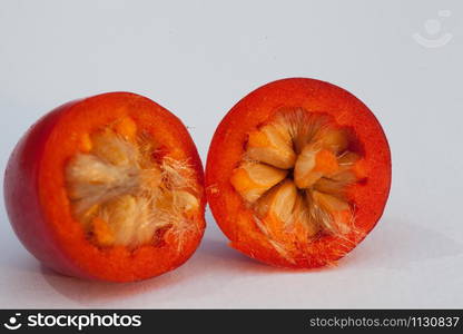 Hawthorn fruits cut in two parts on uniform background