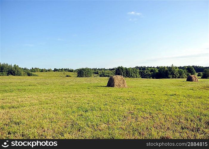 haystack on meadow. summer landscape of countryside