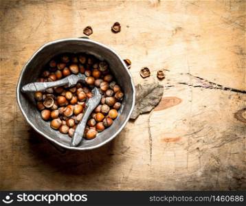 Hazelnuts in the old pot. On a wooden table.. Hazelnuts in the old pot.