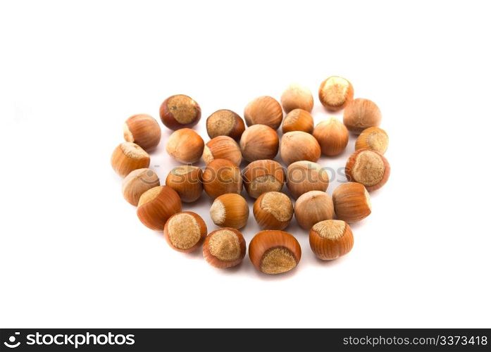hazelnuts in the shape of a heart isolated on white
