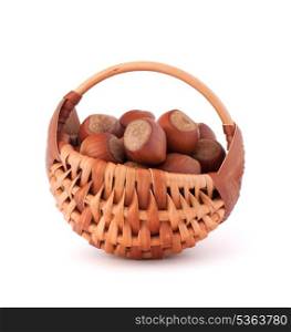 Hazelnuts in wicker basket isolated on white background