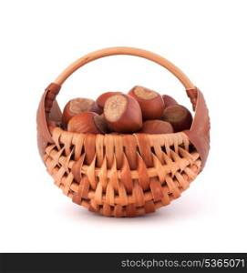 Hazelnuts in wicker basket isolated on white background
