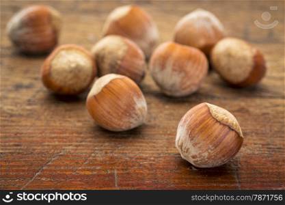 hazelnuts on a grunge wood surface with a selective focus