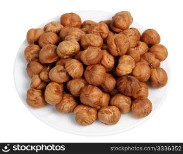Hazelnuts on a white plate on a white background, isolated.