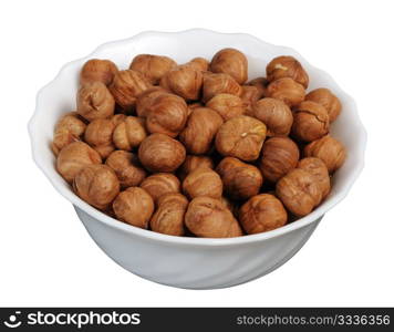 Hazelnuts on a white plate on a white background, isolated.