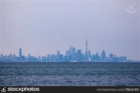 Hazy skyline of Toronto, Ontario, Canada, from across water.
