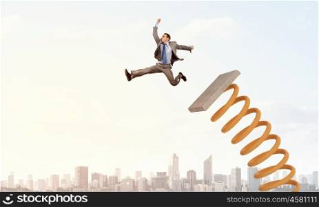 He did great career jump. Businessman jumping on springboard as progress concept