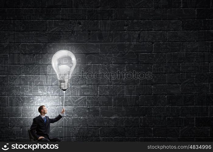 He has good idea. Businessman with bulb on rope representing bright idea