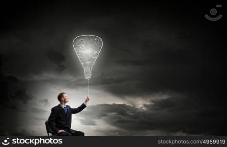 He has good idea. Businessman with bulb on rope representing bright idea