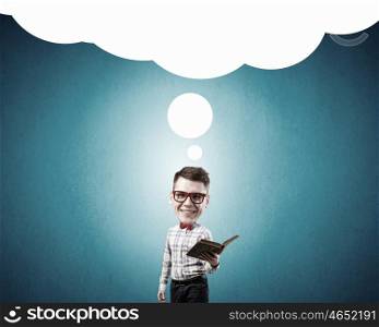He has great mind. Young funny big headed man in glasses with book in hands
