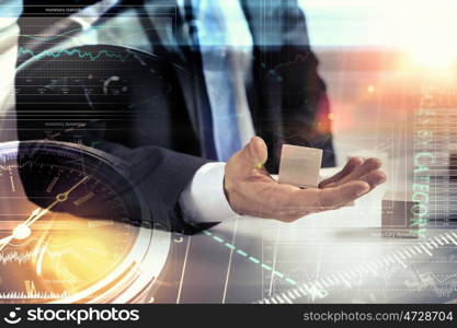 He is building his business. Close view of businessman making pyramid with empty wooden cubes