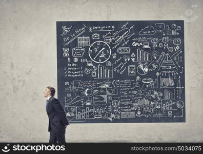 He is carrying out his plan. Young businessman carrying banner with his great business plan