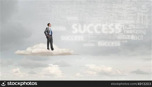 He is confident in his success. Confident businessman with arms on waist standing on cloud