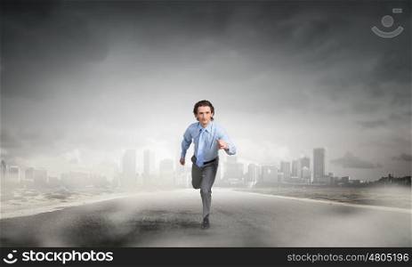 He is determined to start now. Young businessman on road ready to run race
