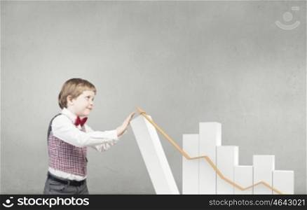 He is future businessman. Little boy businessman and growing bar graph