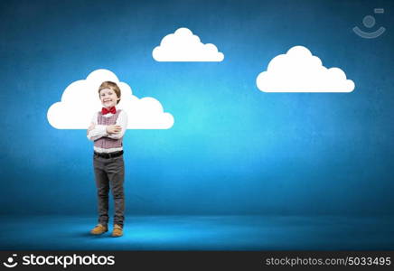 He is little sir. Portrait of little boy with hands folded on chest